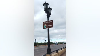 Train derails in Wisconsin near Mississippi River, sending 2 railcars into water