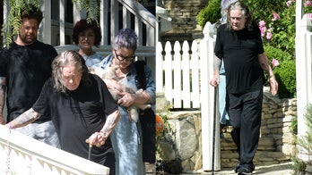 Ozzy Osbourne walks with a cane while out with wife Sharon and family in Los Angeles following 'major' surgery