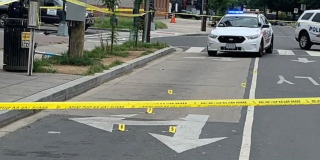 Yellow markers denote bullet casings after three people were injured during a shooting Friday in Washington D.C.