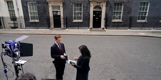 Media gather near 10 Downing Street in London, Thursday, July 7, 2022. Prime Minister Boris Johnson has agreed to resign, his office said Thursday, ending an unprecedented political crisis over his future that has paralyzed Britain's government. 