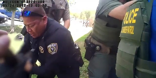 Uvalde police officers and other law enforcement officers are seen responding to a mass shooting at Robb Elementary School in Uvalde, Texas, in a bodycam video recorded on May 24, 2022. 