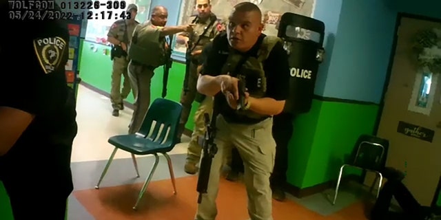 Uvalde police officers and other law enforcement officers are seen responding to a mass shooting at Robb Elementary School in Uvalde, Texas, in a bodycam video recorded on May 24, 2022. 