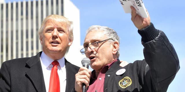 Businessmen Donald Trump and Carl Paladino speak during a pro-gun rally at the Empire State Plaza in Albany, N.Y., April 1, 2014.