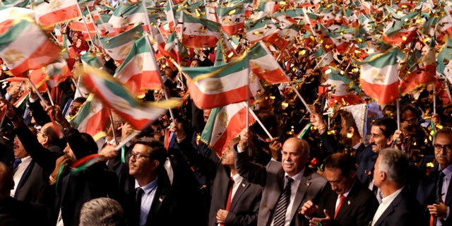 People wave flags during at an event in Ashraf-3 camp, which is a base for the People's Mojahedin Organization of Iran (MEK) in Manza, Albania, July 13, 2019.