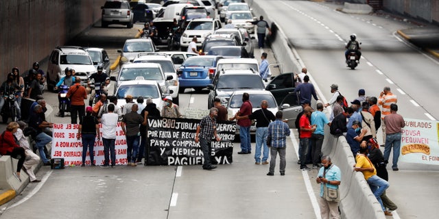 Retired workers of Venezuela’s state-run oil company PDVSA protest outside the company’s headquarters demanding their pension funds, in Caracas, Venezuela, August 3, 2021.