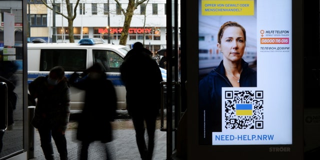 A digital information board at the central station of Duesseldorf, Germany, sends message to female refugees who may be victims of "violence or human trafficking," March 31, 2022.
