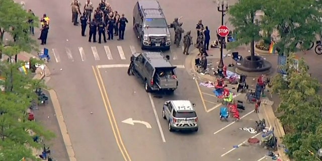 Police deploy after gunfire erupted at a Fourth of July parade route in the wealthy Chicago suburb of Highland Park, Illinois, U.S. July 4, 2022 in a still image from video.