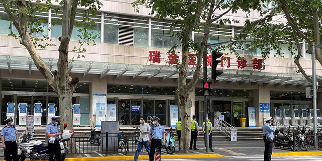 Police officers stand outside the outpatient department of Ruijin Hospital following a stabbing incident, in Shanghai, China July 9, 2022. REUTERS/Brenda Goh
