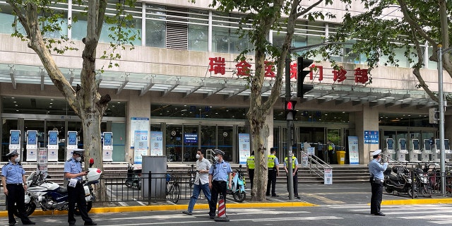 Police officers stand outside the outpatient department of Ruijin Hospital following a stabbing incident, in Shanghai, China July 9, 2022. REUTERS/Brenda Goh