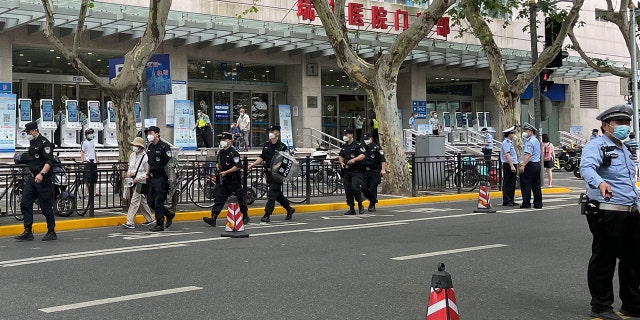 Police officers walk outside the outpatient department of Ruijin Hospital following a stabbing incident, in Shanghai, China July 9, 2022. REUTERS/Brenda Goh
