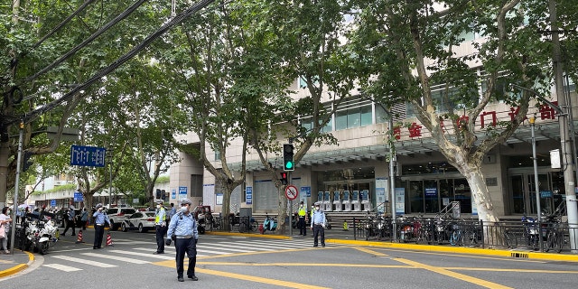 Police officers stand outside the outpatient department of Ruijin Hospital following a stabbing incident, in Shanghai, China July 9, 2022. REUTERS/Brenda Goh
