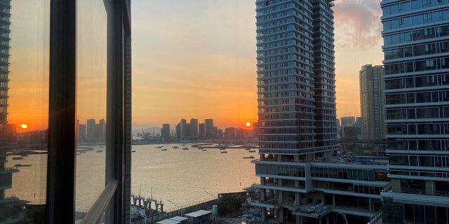 FILE PHOTO: Under-construction apartments are pictured from a building during sunset in the Shekou area of Shenzhen, Guangdong province, China November 7, 2021.