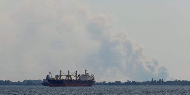 Smoke rises behind a ship on the Dnipro River during the Ukrainian-Russian conflict in the Russian-controlled city of Kherson, Ukraine.