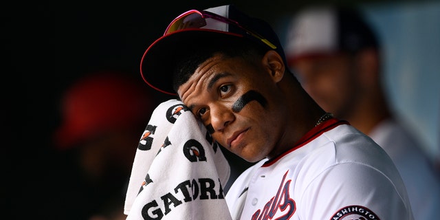 Nationals' Juan Soto wipes his face in the dugout before the Atlanta Braves game, Sunday, July 17, 2022, in Washington.