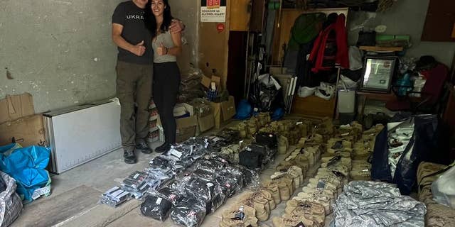 Anastasiya with father Ihor Koval prep supplies for Ukrainian troops with nonprofit Evil Cannot Enter Heaven.