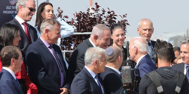 President Joe Biden shakes hands with former Israeli Prime Minister Bibi Netanyahu despite a White House advisory that the president would avoid handshakes due to COVID-19 concerns. 