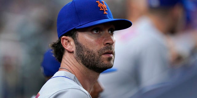 The New York Mets' Tyler Naquin looks out from the dugout during the fifth inning of a game against the Miami Marlins Friday, July 29, 2022, in Miami. New York acquired the left-handed-hitting outfielder and lefty reliever Phillip Diehl Thursday night in a deal for two teenage minor leaguers, outfielder Hector Rodríguez and right-hander Jose Acuña.