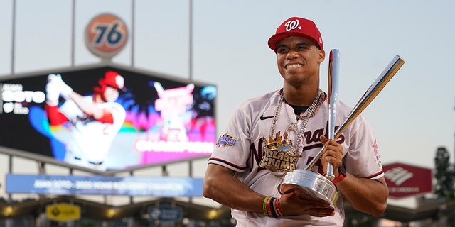 Juan Soto of the National League's Washington Nationals holds the winner's trophy after the MLB Home Run Derby in Los Angeles on July 18, 2022.