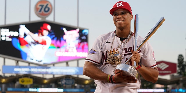 Juan Soto of the National League's Washington Nationals holds the winner's trophy after the MLB Home Run Derby in Los Angeles on July 18, 2022.