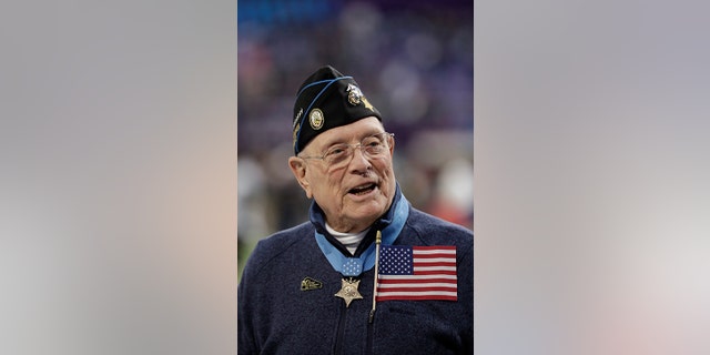 FILE - Woody Williams, 94, the only living Marine Medal of Honor recipient from World War II, gets ready to assist with the coin toss, before the NFL Super Bowl 52 football game between the Philadelphia Eagles and the New England Patriots, Sunday, Feb. 4, 2018, in Minneapolis.