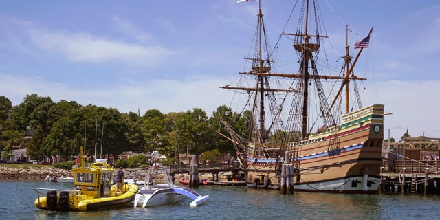 Brett Phaneuf stands on the deck of a tow boat as the Mayflower Autonomous Ship is guided next to the replica of the original Mayflower, on Thursday, June 30, 2022, in Plymouth, Mass. 