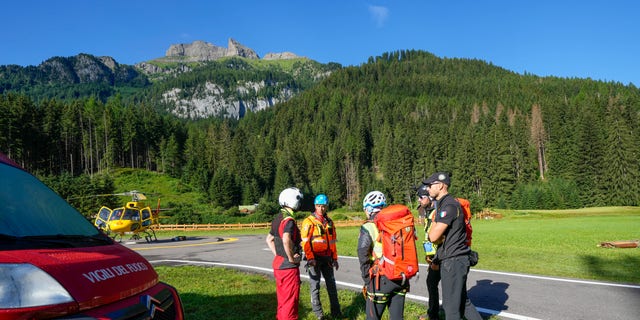 Rescuers prepare to conduct searches for the victims of the Punta Rocca glacier avalanche in Canazei, in the Italian Alps in northern Italy, on Tuesday, July 5. 