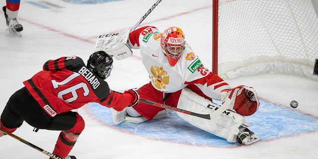 Canada's Conor Bedard (16) scores over Russia goalkeeper Yegor Guskov (29) during the third period of an exhibition hockey game before the IIHF World Junior Hockey Championships tournament in Edmonton, Alberta, Thursday, December 23, 2021.  Yegor Guskov is one of several Russian goaltenders eligible to be included in the 2022 NHL Draft. 