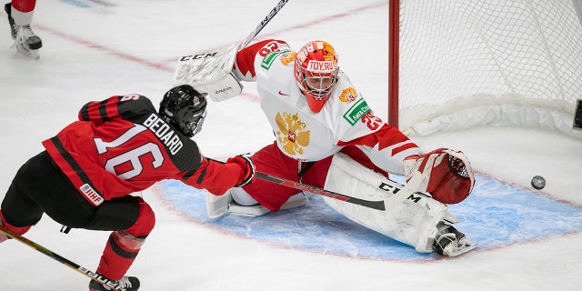 Canada's Connor Bedard (16) scores on Russia goalie Yegor Guskov (29) during the third period of an exhibition hockey game in Edmonton, Alberta, Thursday, Dec. 23, 2021, before the IIHF World Junior Hockey Championship tournament. Yegor Guskov is one of several Russian goaltenders eligible to be taken in the 2022 NHL draft.