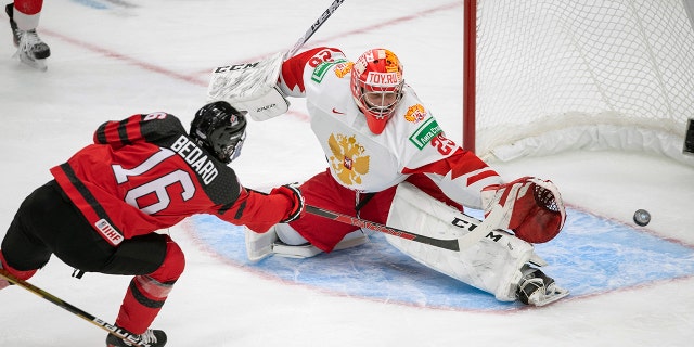 Canada's Conor Bedard (16) scores over Russia goalkeeper Yegor Guskov (29) during the third period of an exhibition hockey game before the IIHF World Junior Hockey Championships tournament in Edmonton, Alberta, Thursday, December 23, 2021.  Yegor Guskov is one of several Russian goaltenders eligible to be included in the 2022 NHL Draft. 