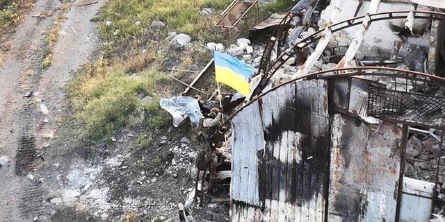 In this photo provided by the Ukrainian Defence Ministry Press Office on Thursday, July 7, 2022, Ukrainian soldiers install the state flag on Snake island, in the Black Sea. The Ukrainian military returned the flag of Ukraine to island, which had been under the control of Russian troops for some time.
