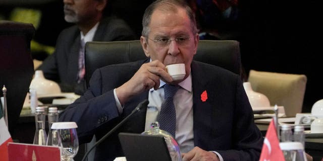Russian Foreign Minister Sergei Lavrov sips his drink prior to the start of the opening session of the G20 Foreign Ministers' Meeting in Nusa Dua, Bali, Indonesia, Friday, July 8, 2022.