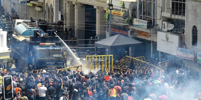 Police will use water canons and tear gas to dissolve protesters in Colombo, Sri Lanka, on Saturday, July 9, 2022. Thousands of people have gone out to the streets of the capital to blame the island nation's worst economic crisis in recent memory.  (AP Photo / Amitha Thennakoon)