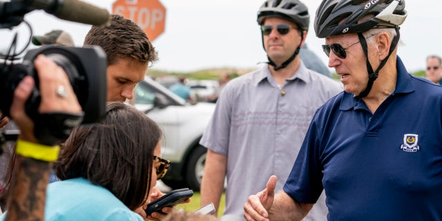 President Joe Biden speaks to members of the media as he goes on a bike ride in Gordons Pond State Park in Rehoboth Beach, Del., Sunday, July 10, 2022.