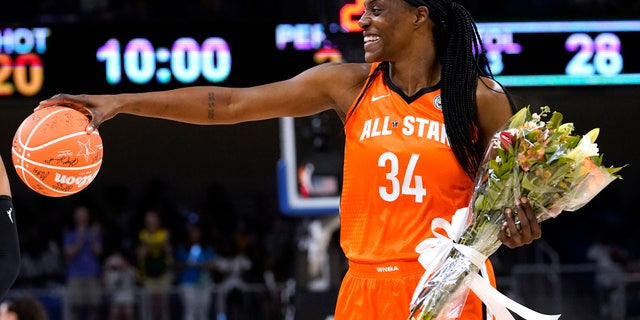 Team Wilson's Sylvia Fowles smiles as she walks to the bench during the first half of a WNBA All-Star basketball game.