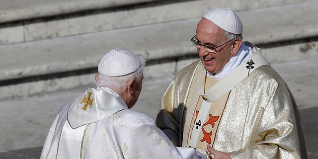 Pope Francis, right, has said that if he retires he will not stay in the Vatican or move back to Argentina.
