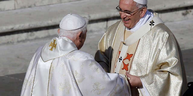 Pope Francis, right, has said that if he retires he will not stay in the Vatican or move back to Argentina.