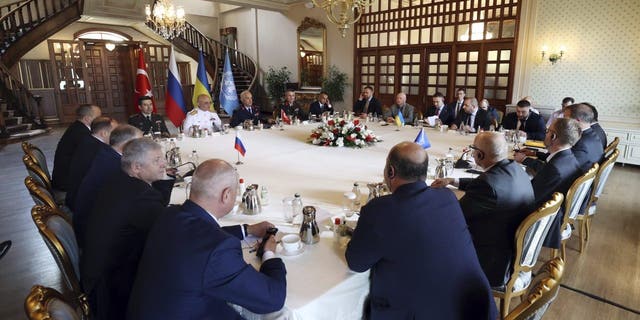 In this handout photo provided by the Turkish Defence Ministry, Russian, left, and Ukranian, top right, delegations meet along with United Nation observers, right, and Turkish Defence Ministry members in Istanbul, Turkey, Wednesday, July 13, 2022. 