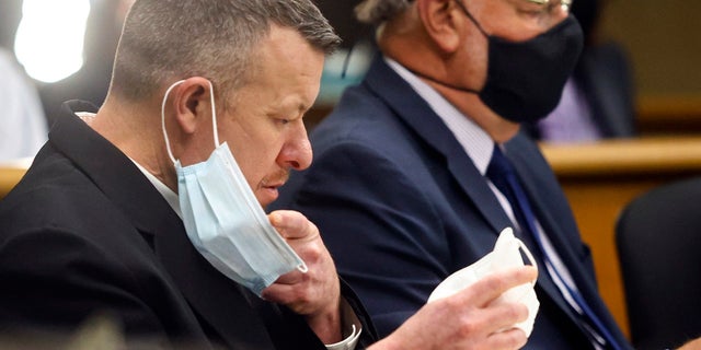 Paul Flores puts on a new N95 mask Aug. 3, 2021, at a preliminary hearing in San Luis Obispo, California. 