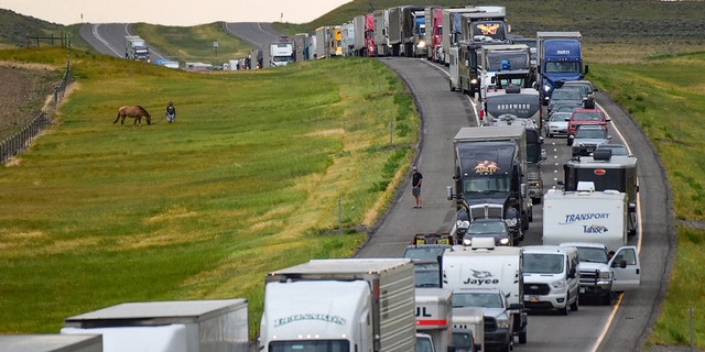Traffic is backed up on Interstate 90 after a fatal pileup where at least 20 vehicles crashed near Hardin, Mont., Friday, July 15, 2022. 