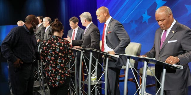 FILE - From right, Rushern Baker, Wes Moore, Doug Gansler and Jon Baron stand at their podiums just before a debate of eight candidates seeking the Democratic nomination for governor of Maryland on Monday, June 6, 2022 in Owings Mills, Md. 