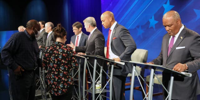 FILE - From right, Rushern Baker, Wes Moore, Doug Gansler and Jon Baron stand at their podiums just before a debate of eight candidates seeking the Democratic nomination for governor of Maryland on Monday, June 6, 2022 in Owings Mills, Md.
