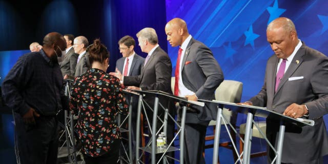 FILE - From right, Rushern Baker, Wes Moore, Doug Gansler and Jon Baron stand at their podiums just before a debate of eight candidates seeking the Democratic nomination for governor of Maryland on Monday, June 6, 2022 in Owings Mills, Md. 