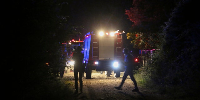 Firefighting vehicles are seen near the site of a plane crash, a few miles away from the city of Kavala, in northern Greece, on Saturday, July 16, 2022.