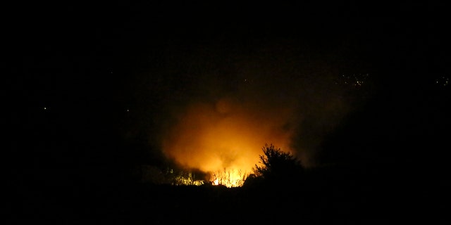Flames are seen at the crash site of a plane, a few miles from the city of Kavala, in northern Greece, on Saturday, July 16, 2022.