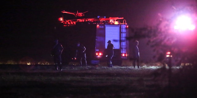 Firefighters are seen near the site of a plane crash, a few miles away from the city of Kavala, in northern Greece, Saturday, July 16, 2022.