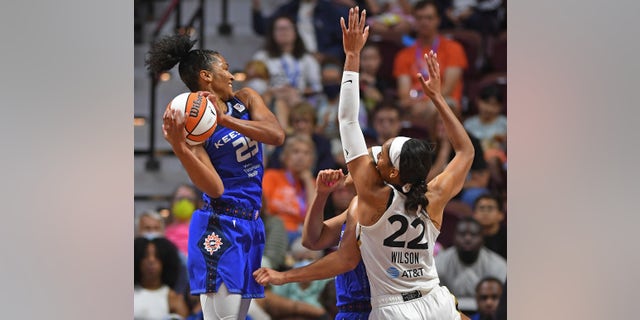 Connecticut Sun forward Alyssa Thomas gets the offensive rebound over teammate Brionna Jones and Las Vegas Aces forward A'ja Wilson during a WNBA game. Becky Hammond has been leading the Aces to a great season.