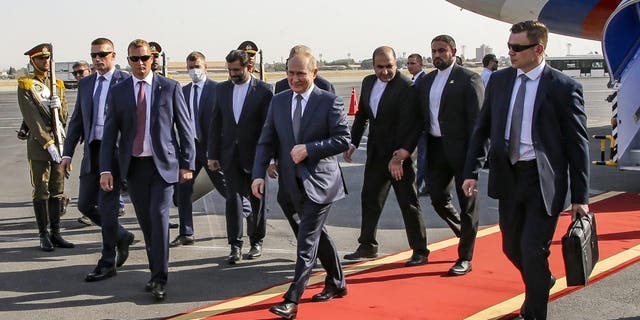 Russian President Vladimir Putin, center, upon his arrival at an international airport outside Tehran, Iran, Tuesday, July 19, 2022. 