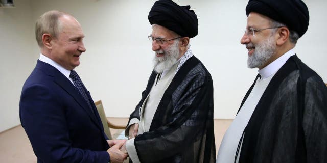 In this image released by the official website of Iran's Supreme Leader's Office, Supreme Leader Ayatollah Ali Khamenei, center, and Russian President Vladimir Putin, left, greet each other as Iranian President Ebrahim Raisi stands at right, during their meeting in Tehran, Iran on Tuesday, July 19, 2022. 