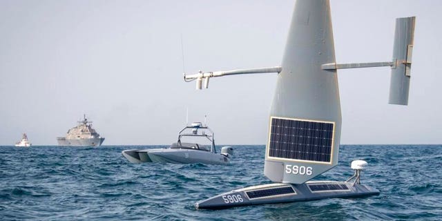 This image provided by the U.S. Navy shows, from front, a Saildrone Explorer, a Devil Ray T-38 crewless vessel, a littoral combat ship and a U.S. Coast Guard cutter in the Arabian Gulf on June 26, 2022.