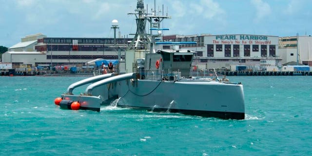 In this image provided by the U.S. Navy, a Sea Hunter crewless vessel arrives at Pearl Harbor, Hawaii, to participate in the Rim of the Pacific exercise, June 29, 2022.